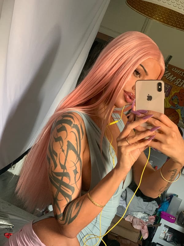 Woman in pink wig takes selfie in London