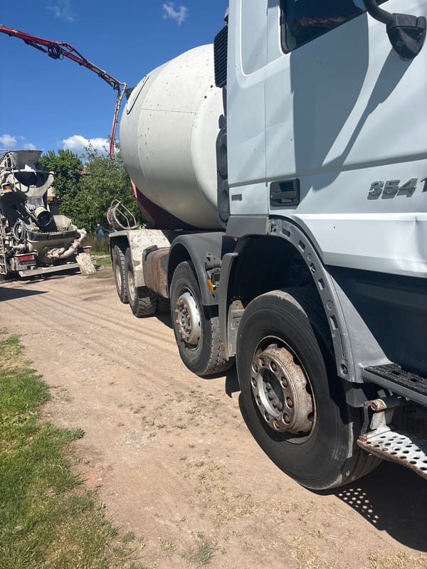 Concrete mixer truck parked on dirt road in Bulgarian village