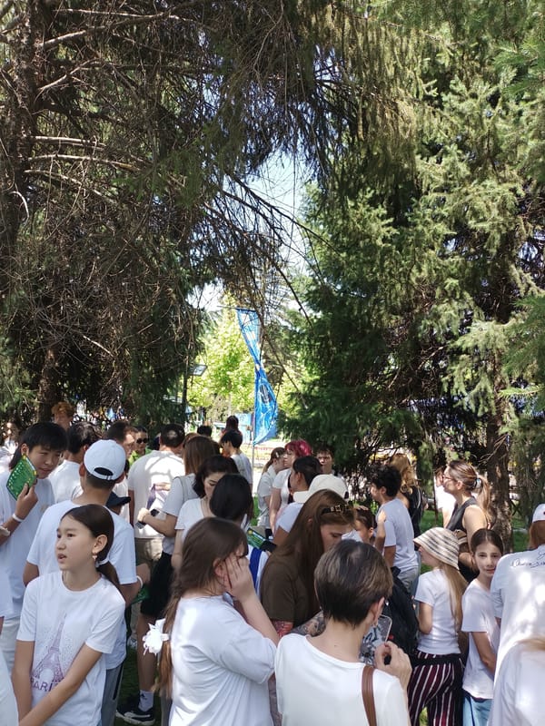 White-shirted crowds gather across Almaty parks in early morning