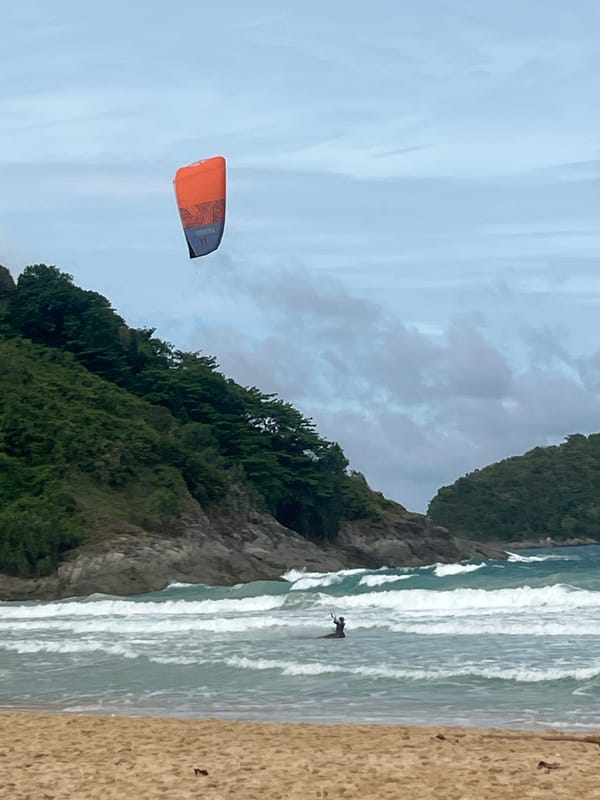 Early morning kiteboarding and beach activity in Rawai Thailand