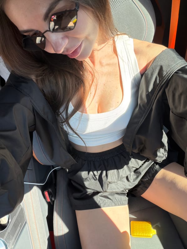 Woman rests in passenger seat of car in Krasnoyarsk