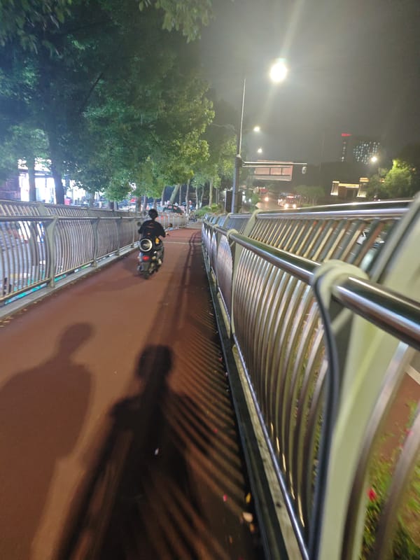 Nighttime traffic and pedestrian activity documented in Chongqing tech district
