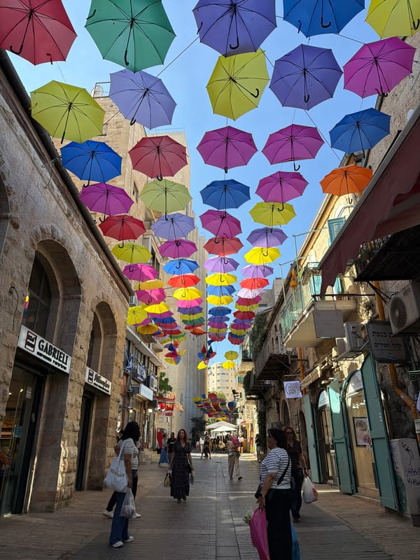 Jerusalem Old City market stroll with umbrella canopies and ceramics
