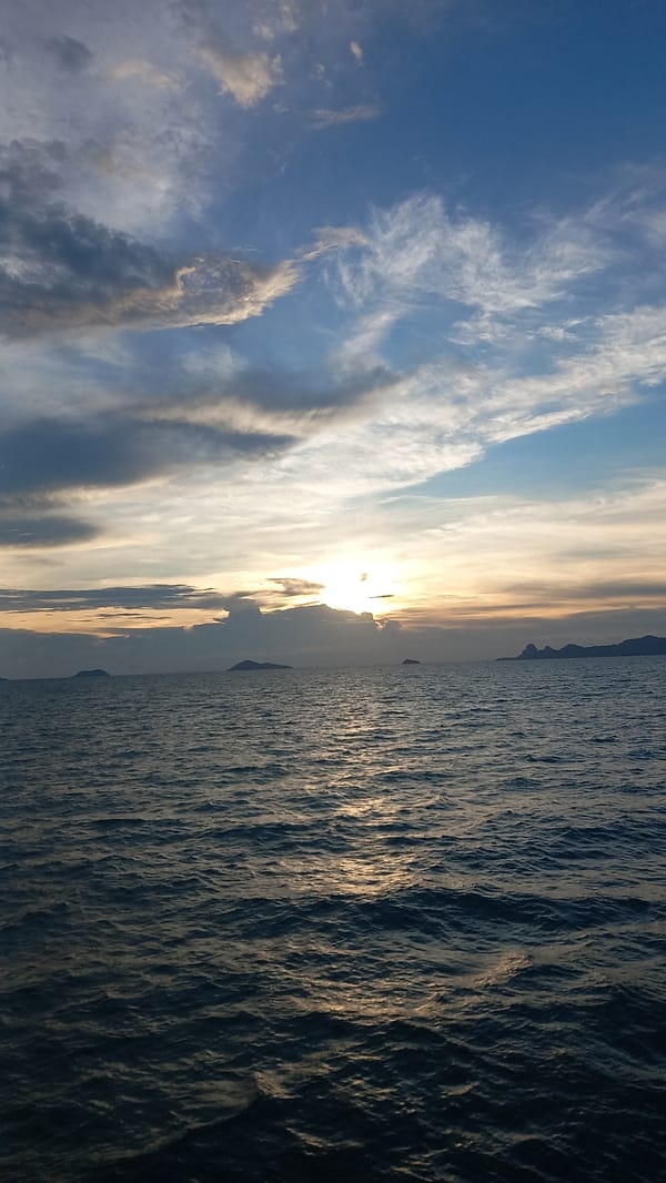Sunset captured over Thai ocean waters with distant islands