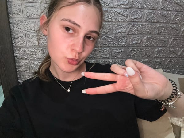 Woman takes selfies on bed in Panagyurishte, Bulgaria