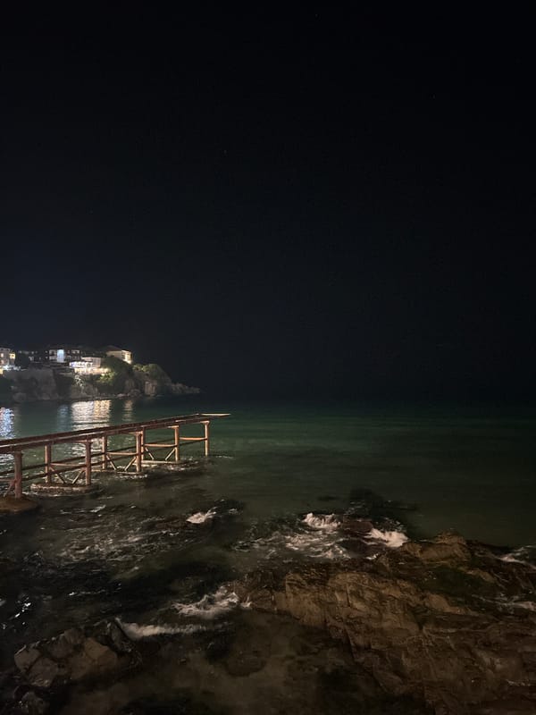 Sozopol's lit coastline meets the Black Sea at night