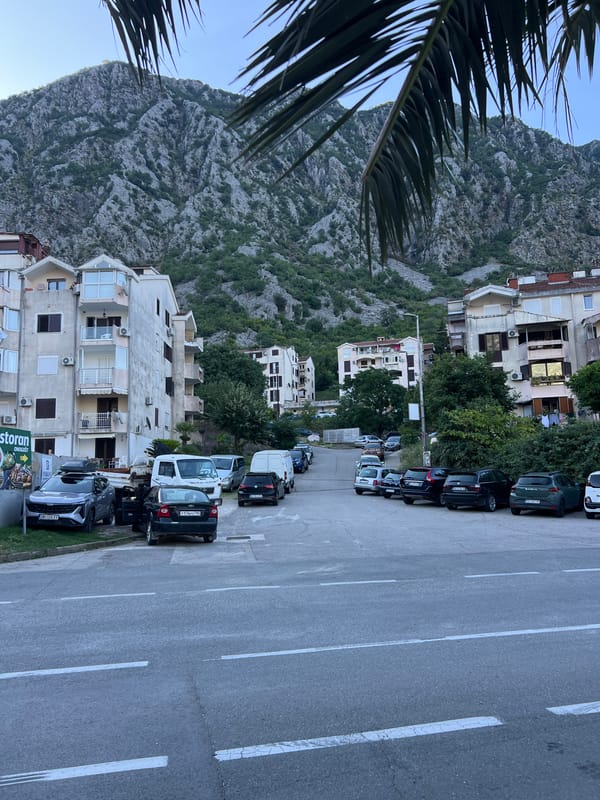 Risan, Montenegro: bay, boats, coastal road, and mountain streets