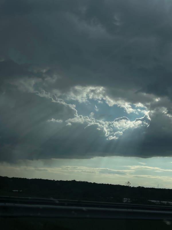 Sunbeams pierce dark clouds over Bulgarian village