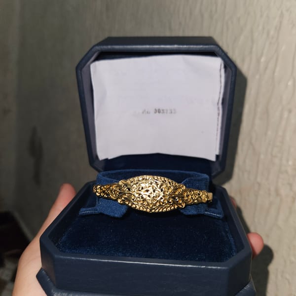 Person examines gold jewelry at Fez shops