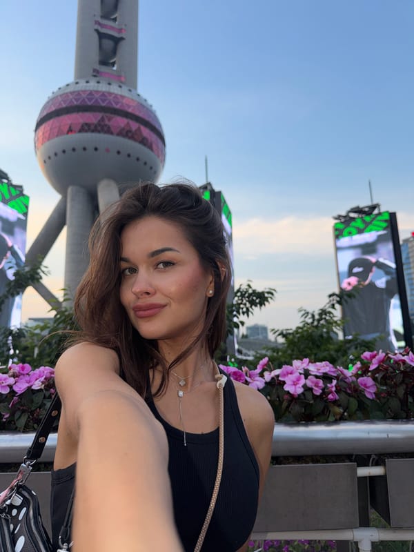 Tourists photograph themselves at Shanghai's Oriental Pearl Tower