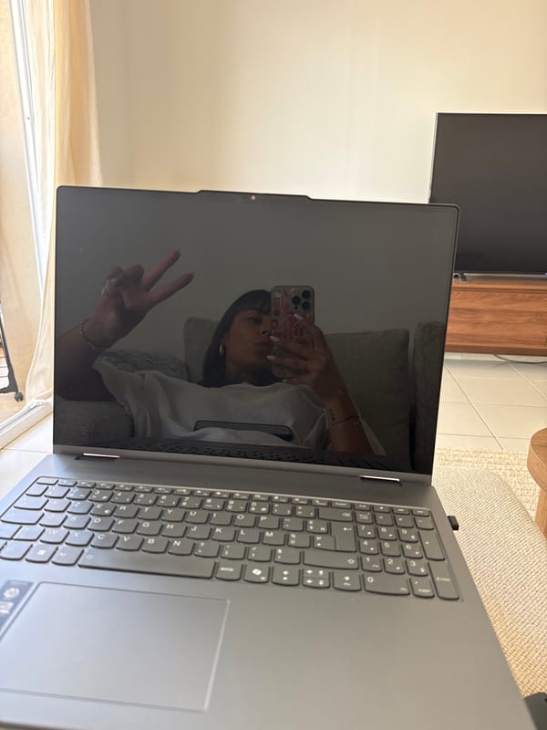 Woman documents remote work session from Cannes sofa