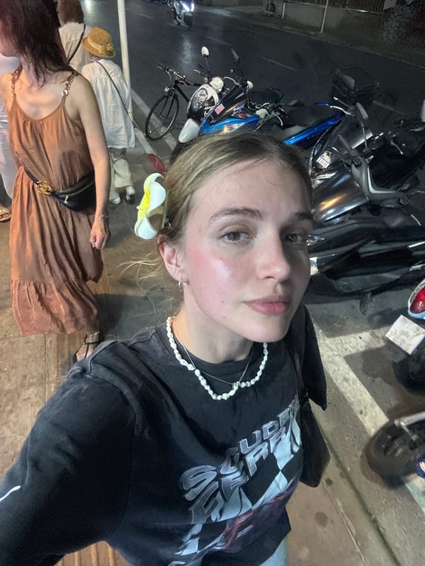 Woman photographed twice on Patong street near tsunami signs