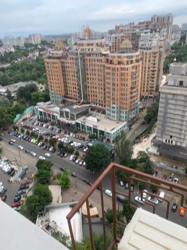 Rooftop aerial views of a dense city block anchored by a glass mall
