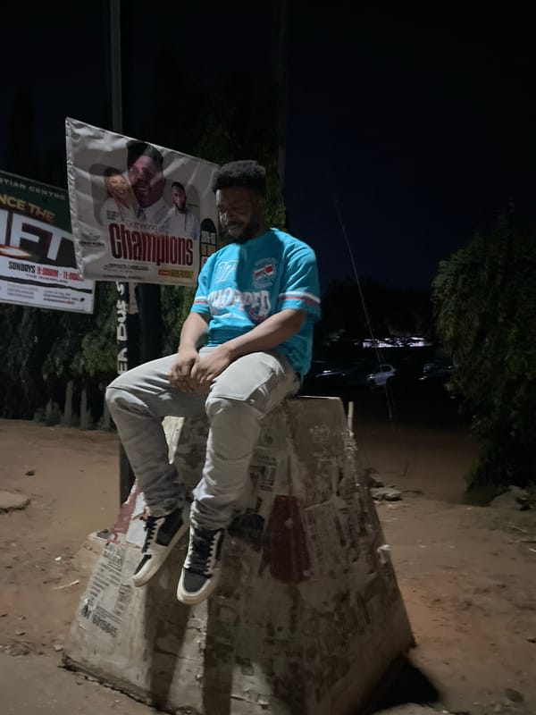 Man rests on concrete with papers in Abuja