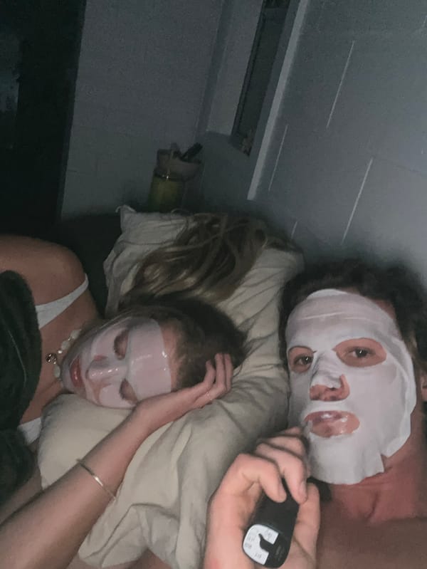 Two people resting in bedroom in Bulli, Australia