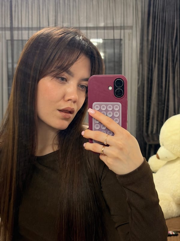 Woman takes selfies indoors in Votkinsk with cat present