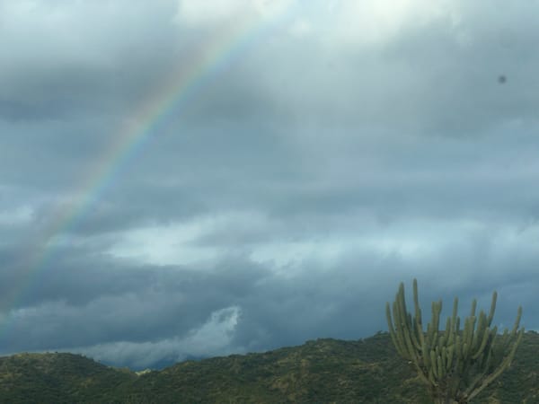 Rainbow spotted over Catamarca desert landscape with construction activity