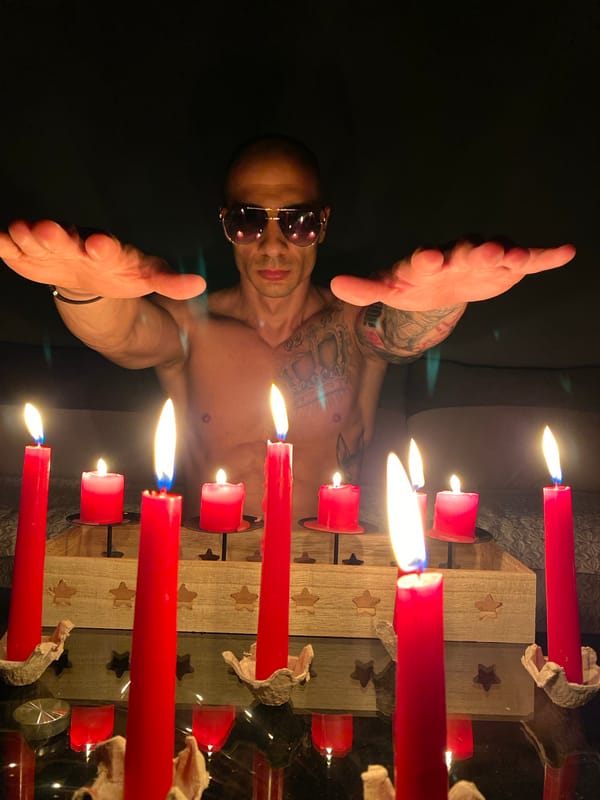 Tattooed man observed in candlelit scene in Pleven, Bulgaria