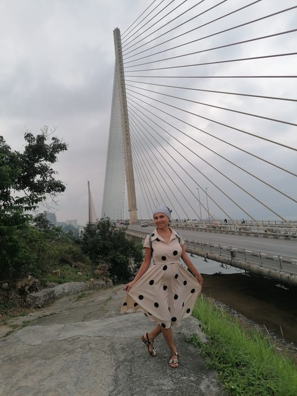 Tourist documents Ha Long Bay bridge visit during morning