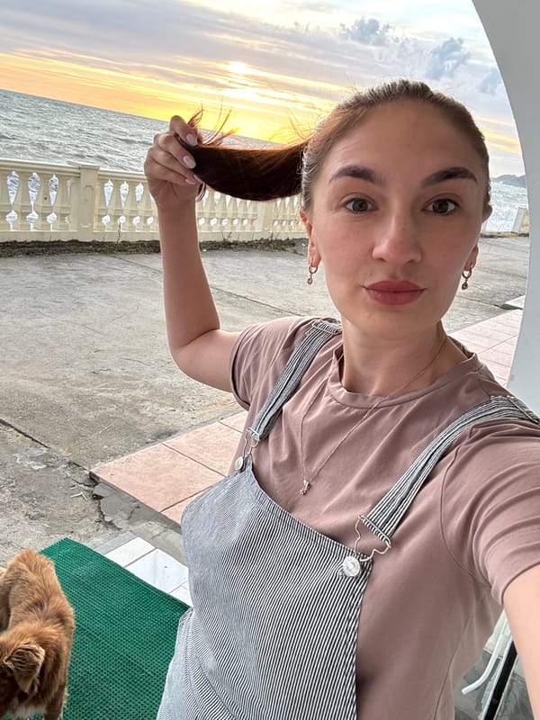 Woman enjoys sunset moments with dog at Sochi waterfront