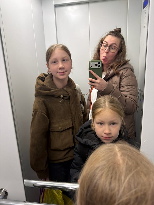 Family Takes Mirror Selfie in Elevator
