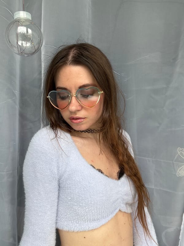 Indoor portrait, light blue fuzzy sweater and black choker