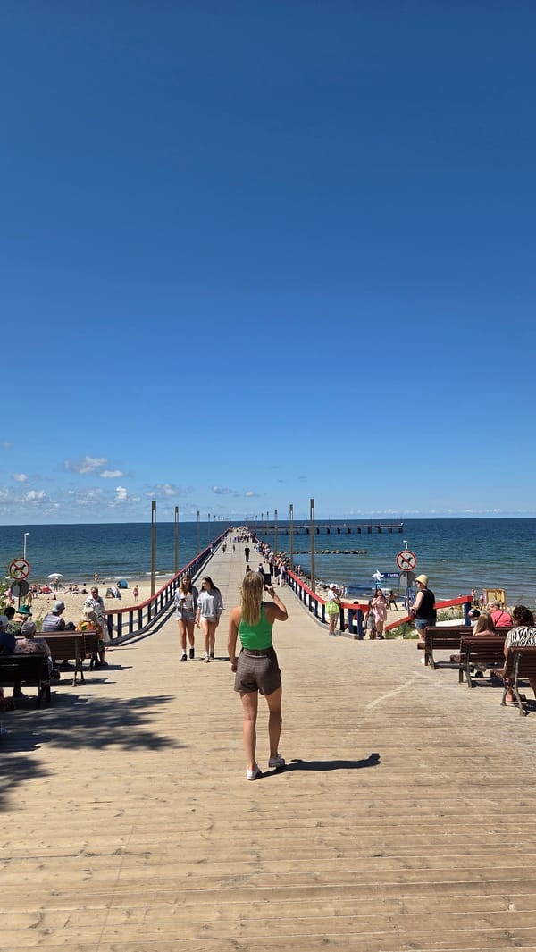 Palanga pier, beach, and amusement area on a sunny summer morning