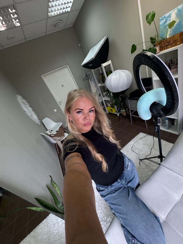 Woman documents photo session with professional lighting setup