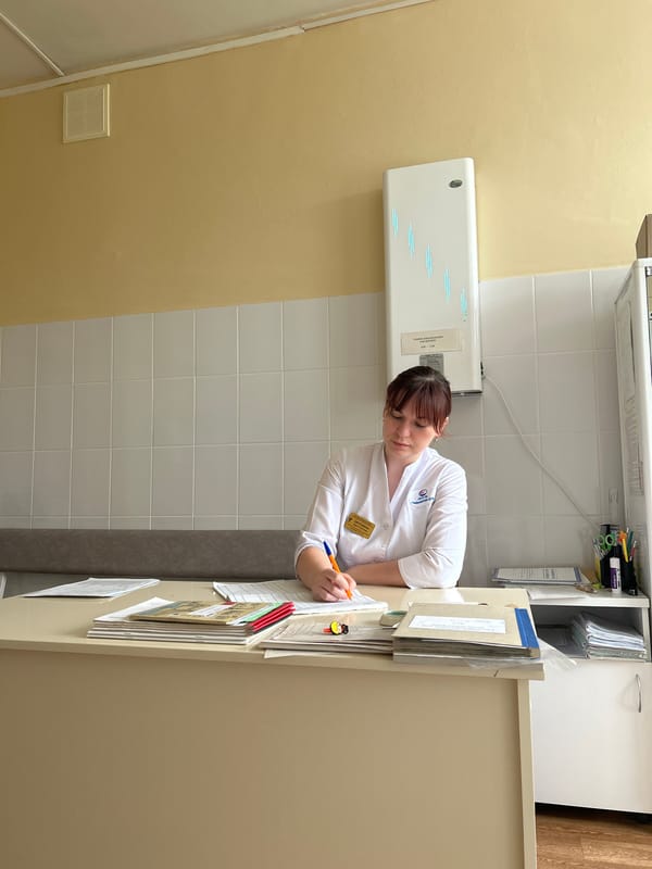 Medical worker observed writing at desk in Russian clinic