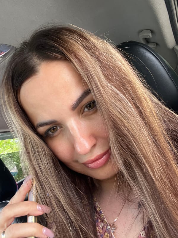 In a parked car with a book, a phone, and a floral dress