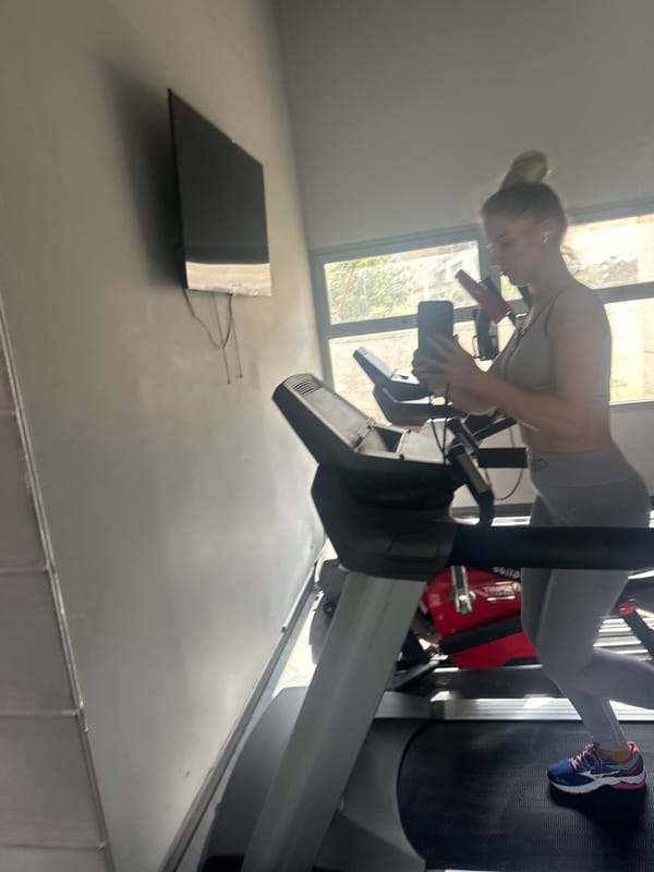 Woman takes selfie while exercising on treadmill in Petah Tikva