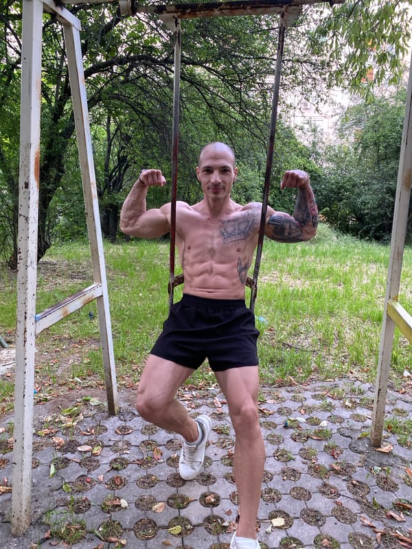 Man performs calisthenics workout on playground equipment in Bulgaria