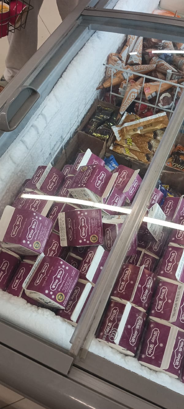 Shopper documents retail displays across Peshawar stores in evening