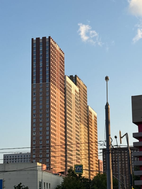Golden hour light hits Moscow streets and modern apartment blocks
