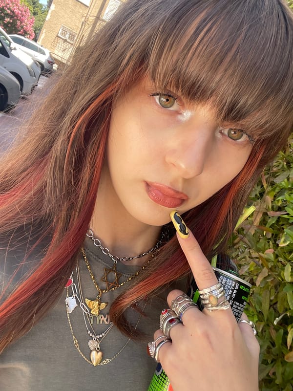 Woman enjoys energy drink in Raanana selfie moment
