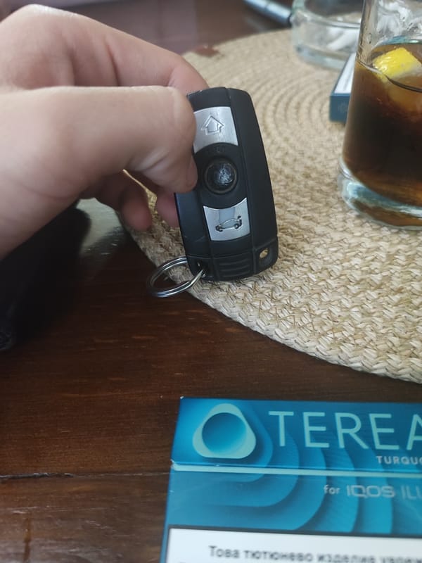 BMW owner enjoys drink and tobacco in Bulgarian town