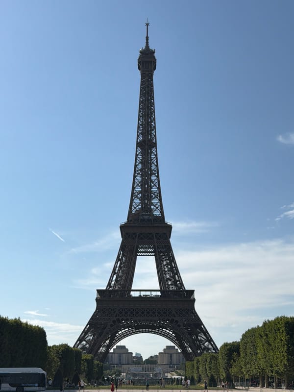 Multiple angles on the Eiffel Tower under a clear Paris sky