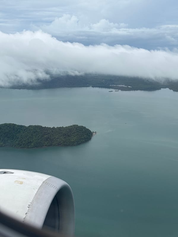 Aerial window view over a forested Thai island