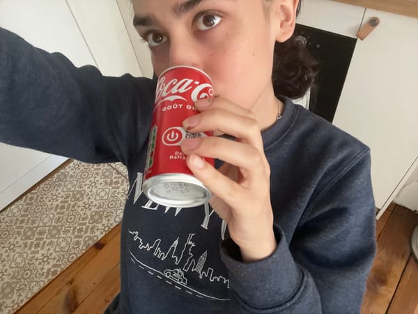 Person enjoys Coca-Cola and snacks in Lyon apartment