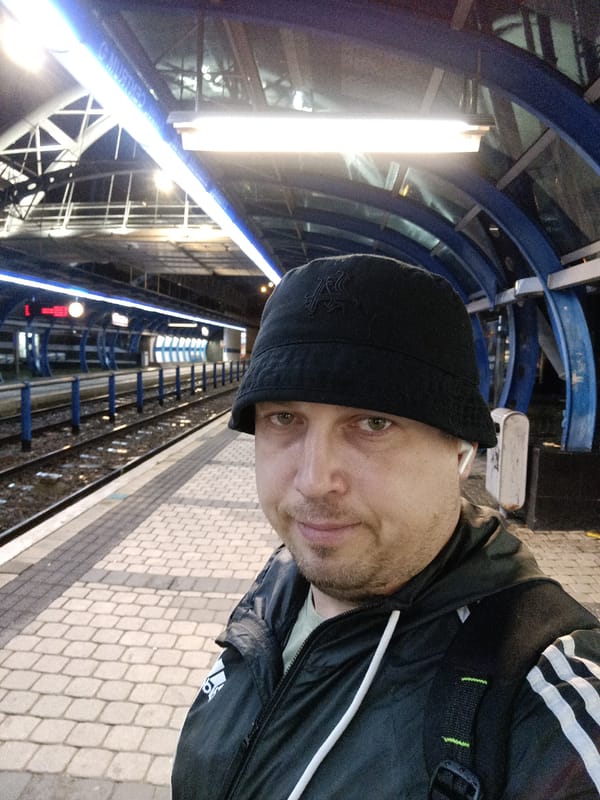 Man in bucket hat travels Prague public transit system
