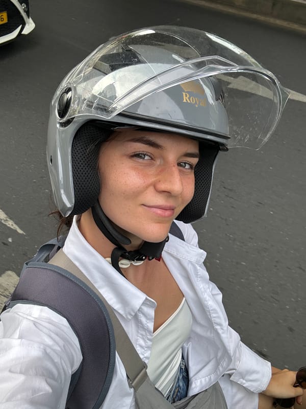 Woman in motorcycle helmet takes selfie in Thủ Đức