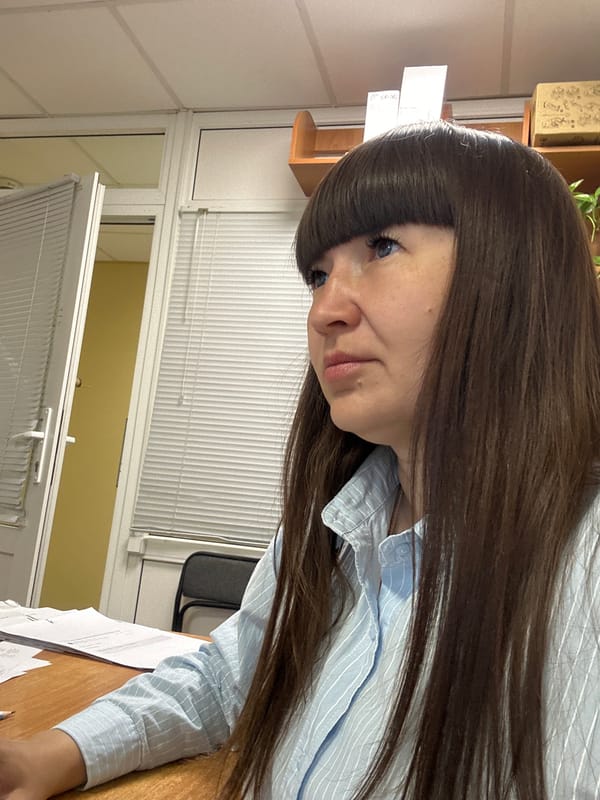 Woman at desk with papers observed in Chaikovsky, Russia
