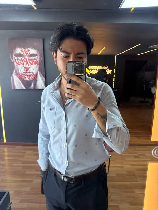 Young man takes mirror selfie at modern Puebla barbershop