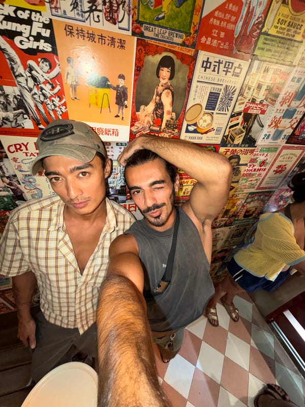 Tourists pose at vintage poster-decorated venue in Mengwi