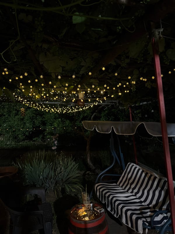 Fairy-lit pergola garden spot in Baurene on a summer night