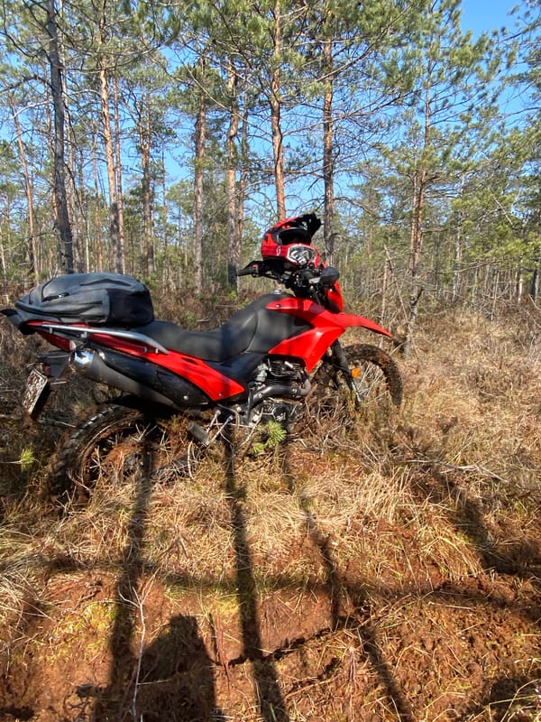 Muddy dual-sport motorcycle spotted in Belarus countryside
