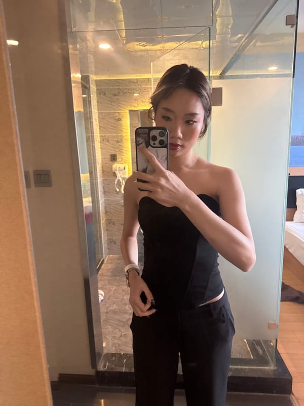 Woman takes mirror selfies in Ganzhou hotel bathroom