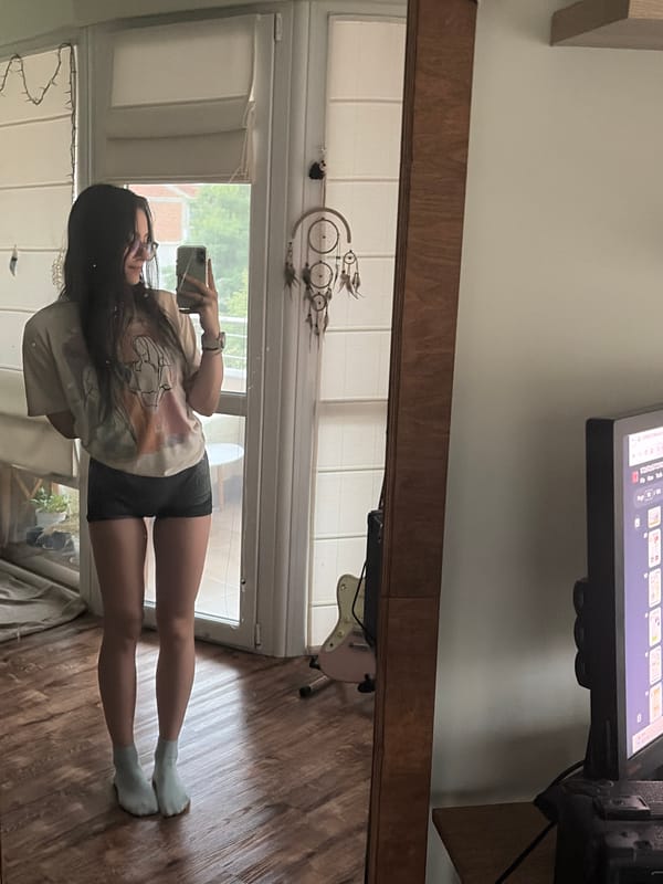 Mirror selfies at home with a cloudy city backdrop