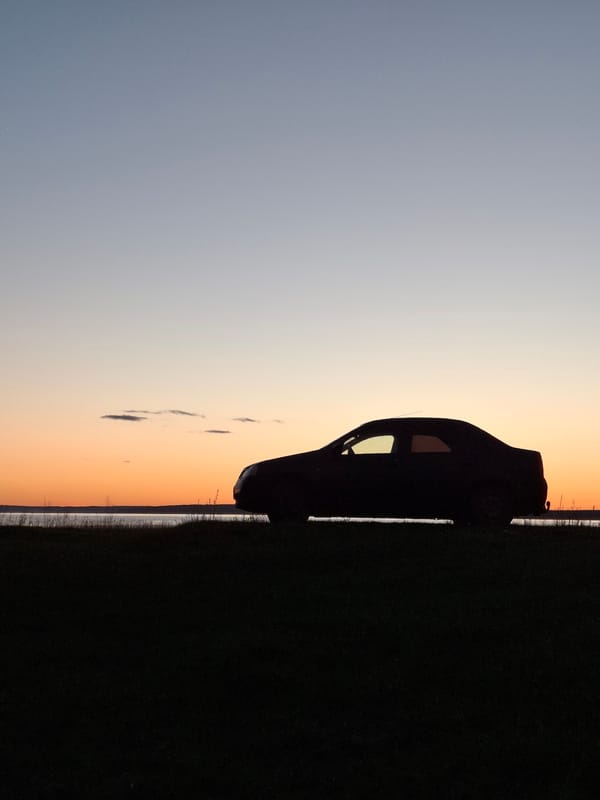Car silhouetted against sunset sky in Plishkino, Russia