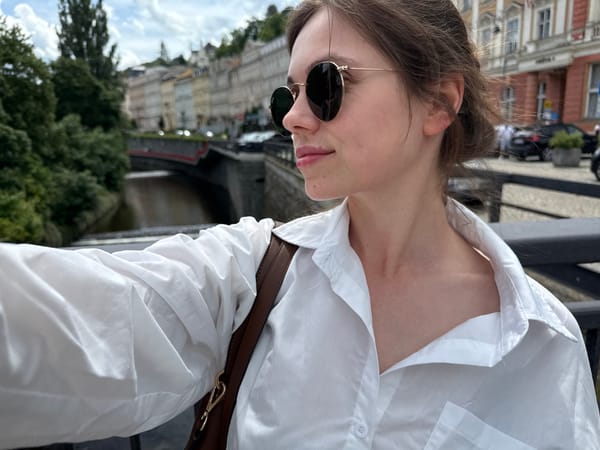 Tourist documents historic Karlovy Vary architecture during morning walkabout